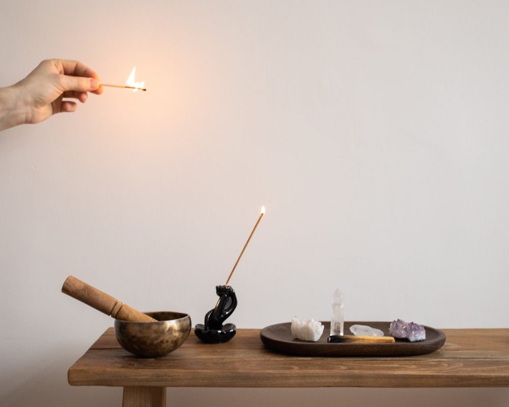 A table of alternative healing implements: incense, crystals.