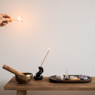 A table of alternative healing implements: incense, crystals.