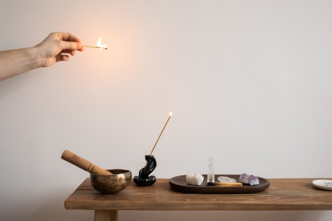 A table of alternative healing implements: incense, crystals.